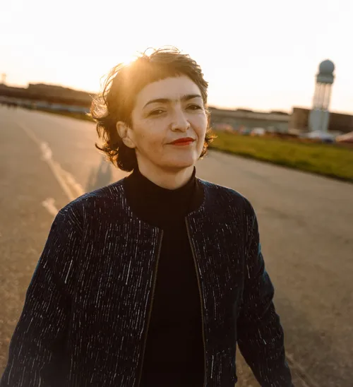 Person standing outside in golden light.