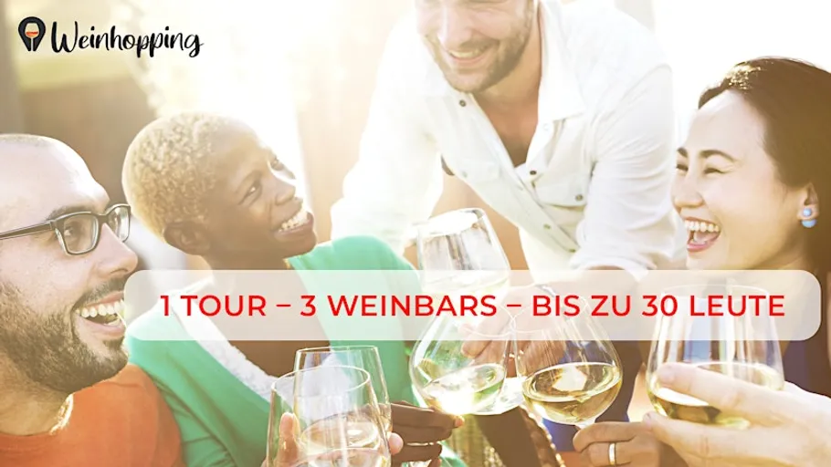Four people smiling with wine glasses outdoors.