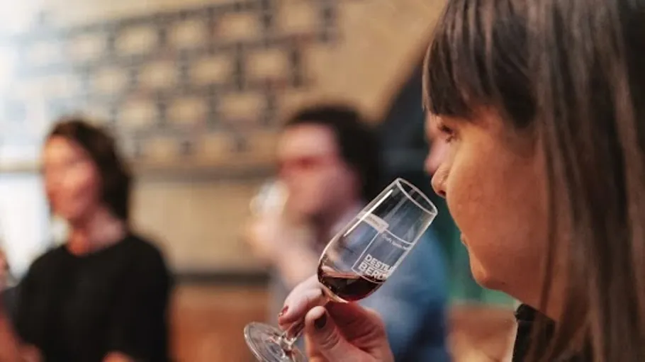 Woman smelling wine in a tasting room.
