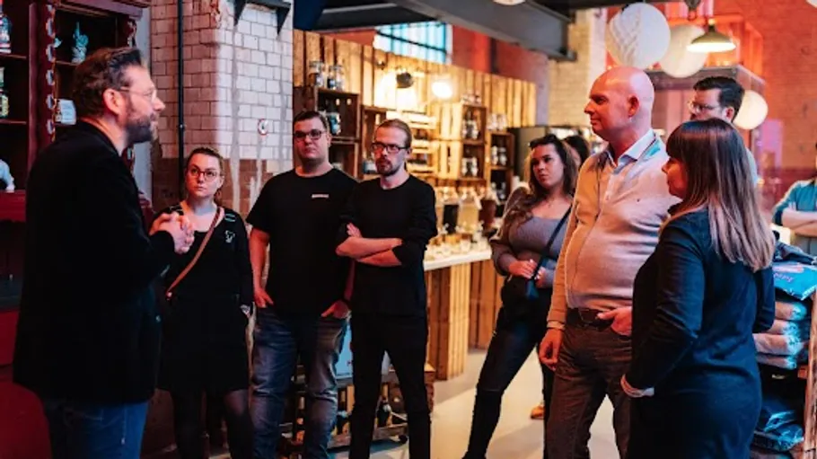 Group listens to speaker in industrial space.
