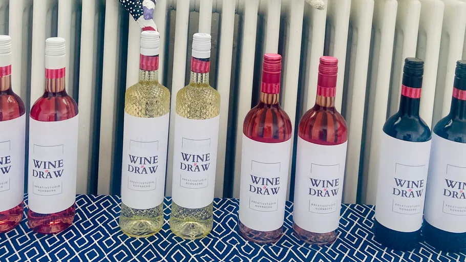 Bottles of wine on patterned tablecloth.