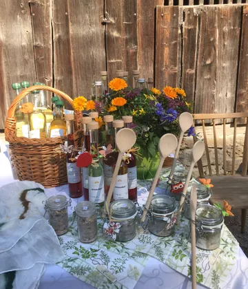 Colorful bottles and jars on rustic table setting.