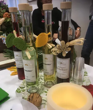 Bottles of herbal liqueur on display table.