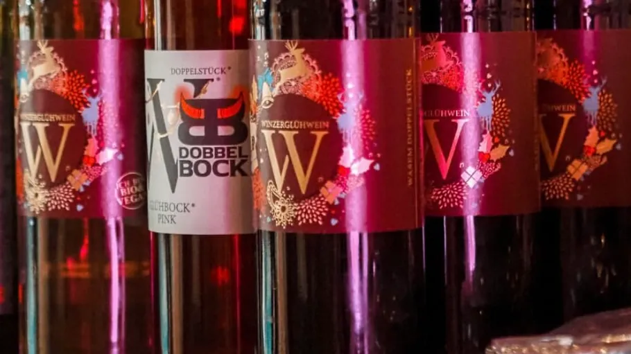 Bottles of wine with colorful labels displayed.