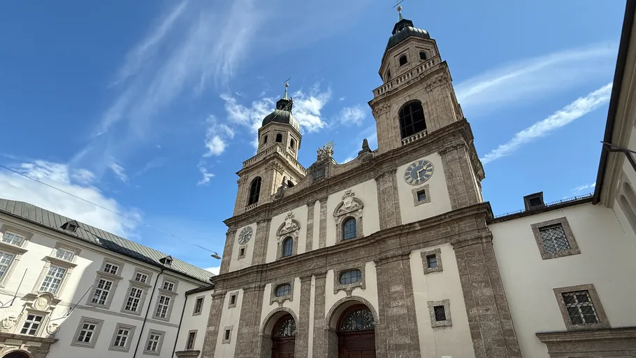 Historic church with twin towers and blue sky.