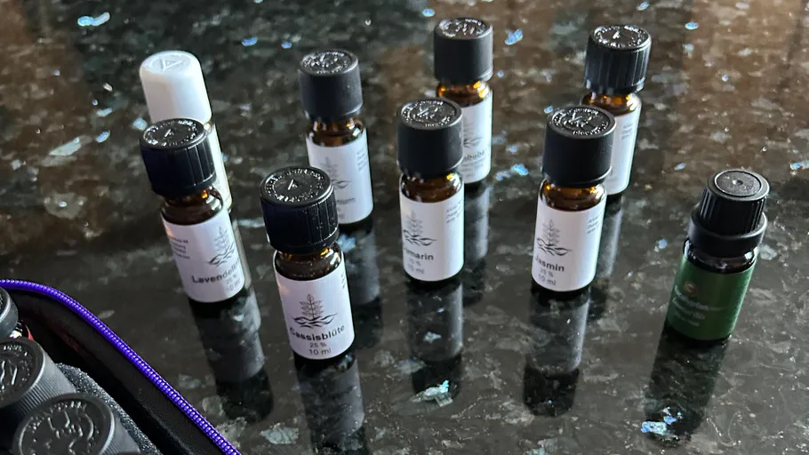 Essential oil bottles on a dark countertop.