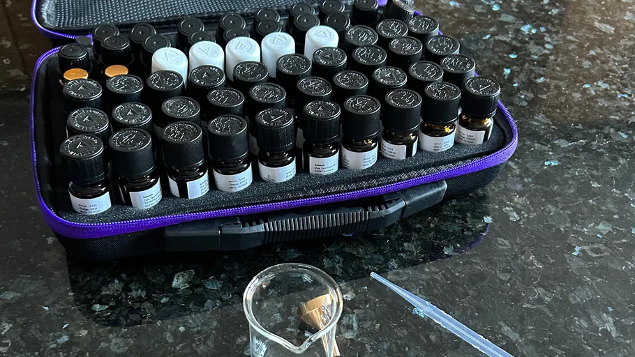 Aromatherapy bottles in a case on countertop.