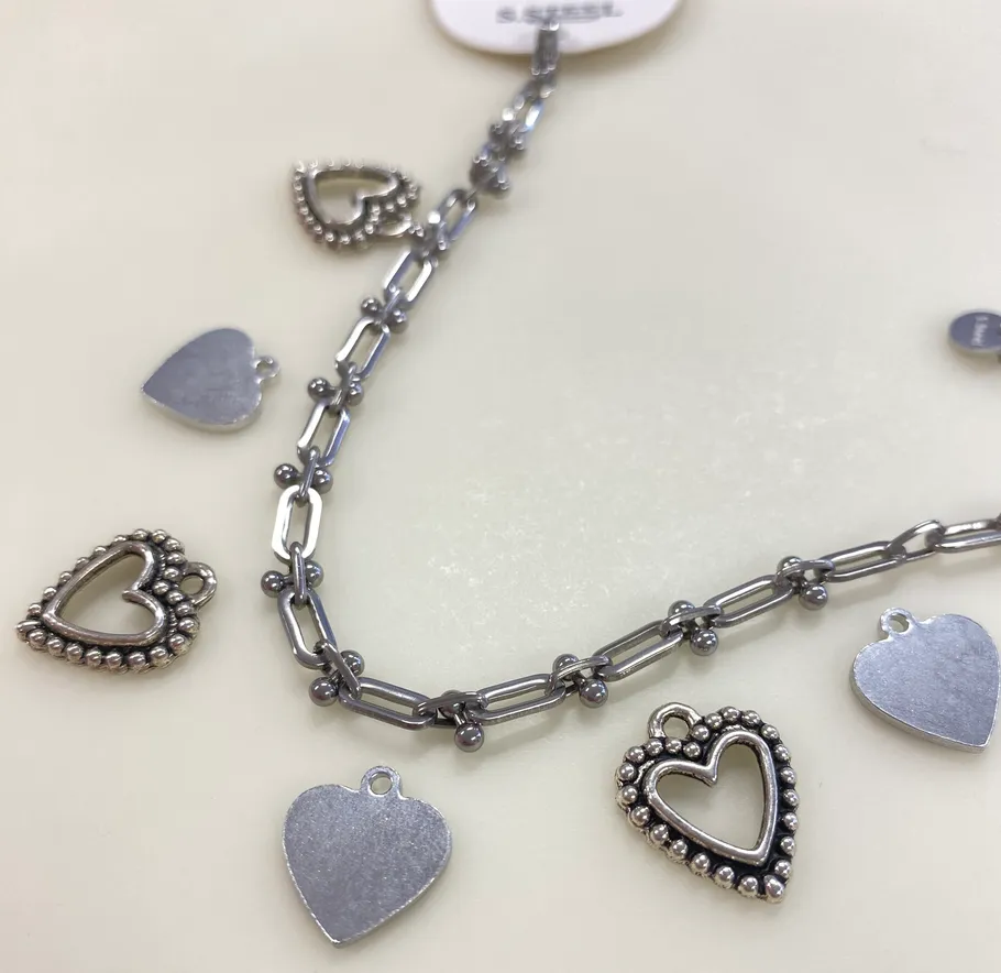 Silver charm bracelet with heart pendants.