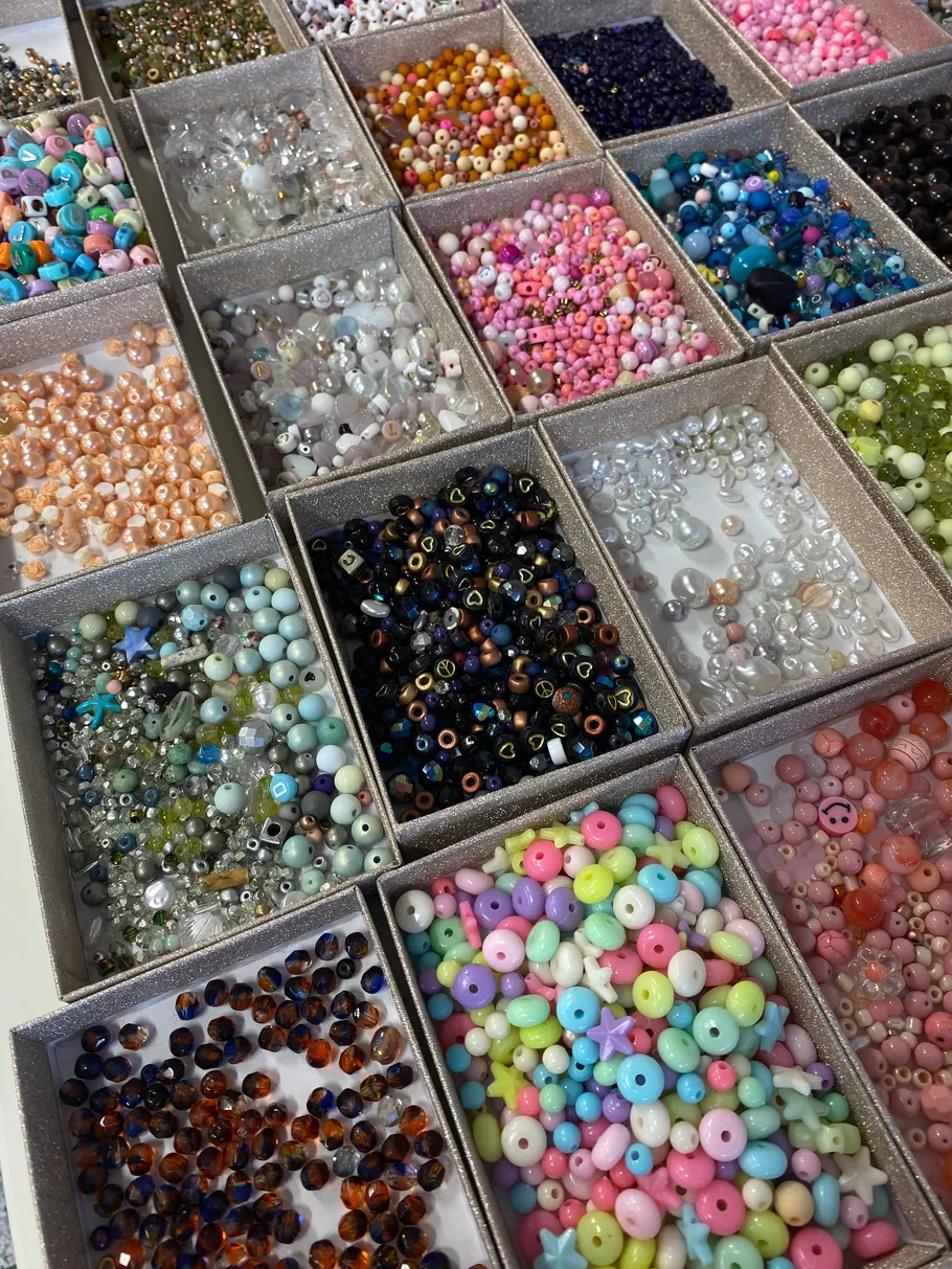 Colorful beads organized in small boxes.