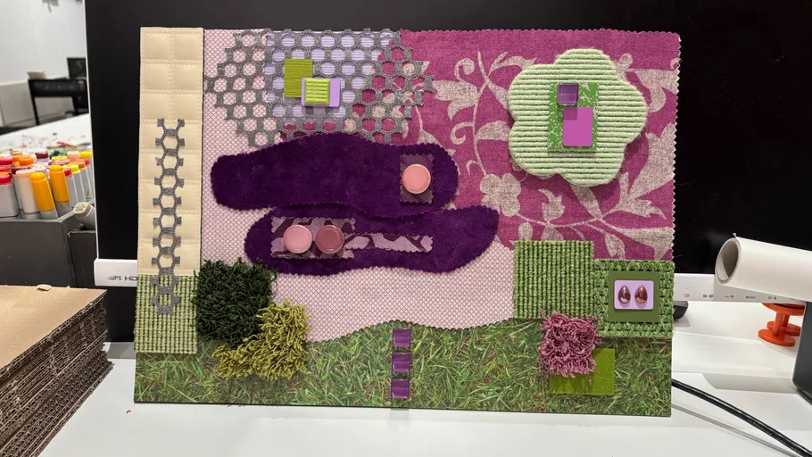 Textured fabric collage on a workspace table.
