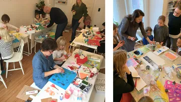 Kinder basteln mit Erwachsenen im Klassenraum.