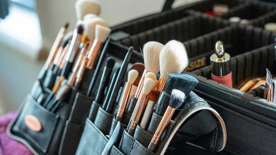 Makeup brushes organized in a black case.