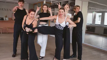 Gruppe posiert spielerisch im Tanzstudio.