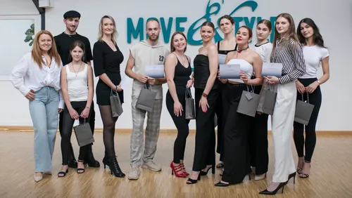 Group of people posing in dance studio.