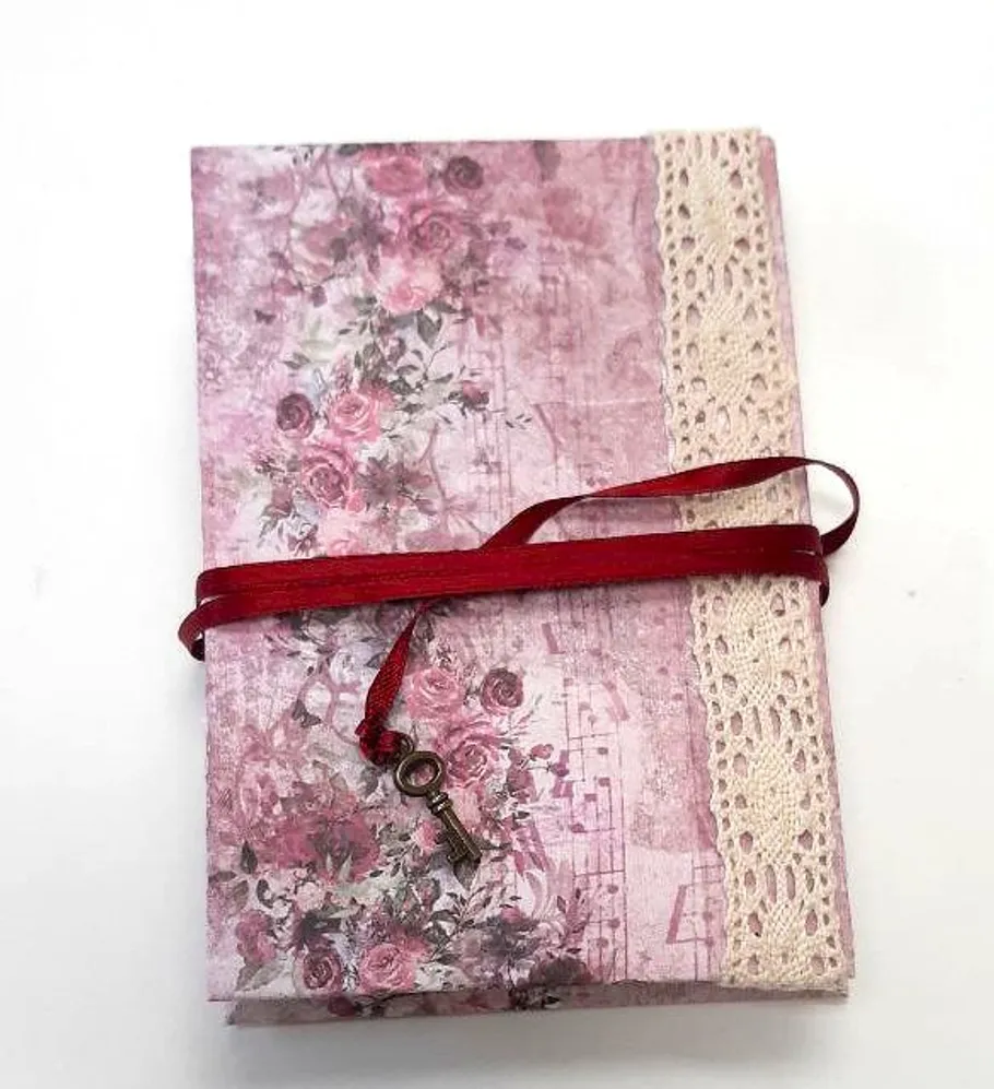 Decorative journal wrapped in red ribbon.