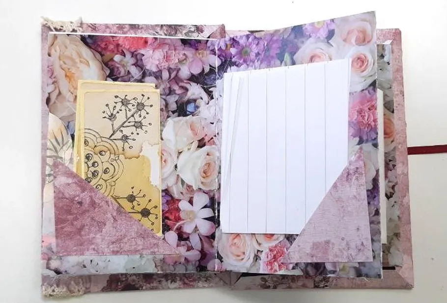 Open scrapbook with floral design pages.