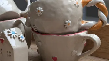 Decorative cups with heart and flower designs.