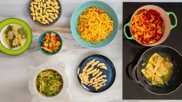 Various pasta dishes on a marble surface.