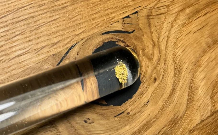 Resin drop embedded in wooden surface.