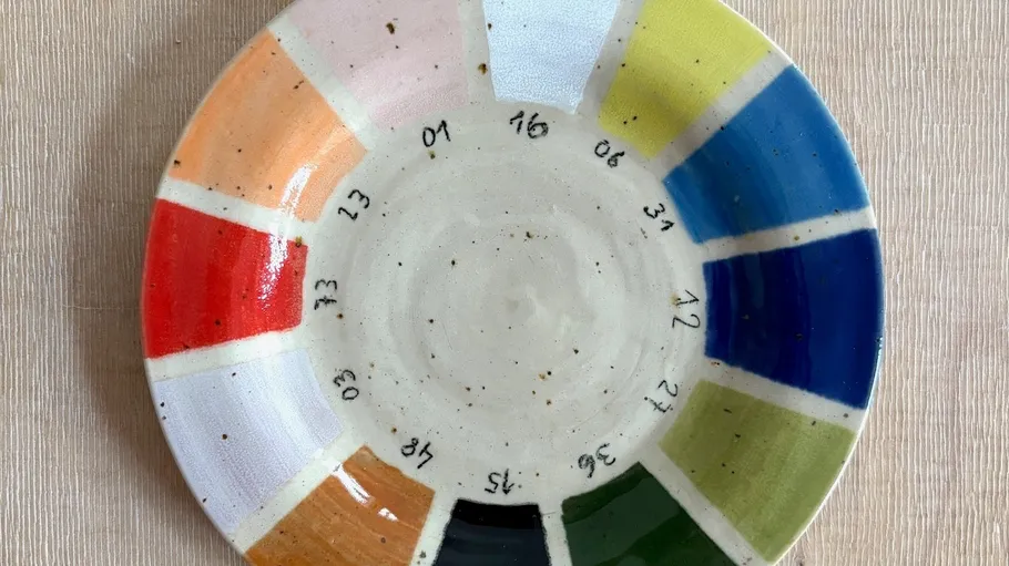 Colorful ceramic plate with numbered sections.
