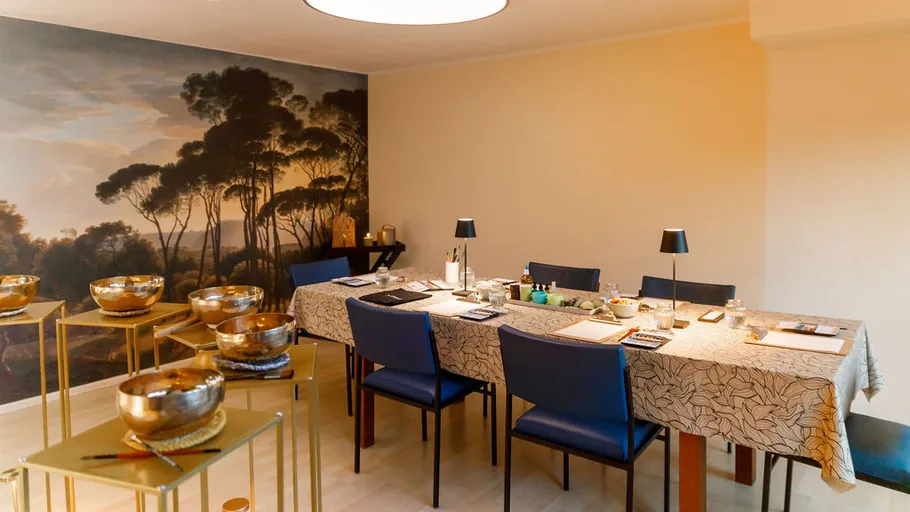 Dining room with paintings and blue chairs.
