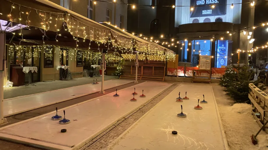 Ice curling track with festive lights.