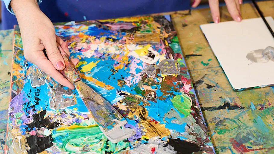 Hand painting on colorful canvas with palette knife.