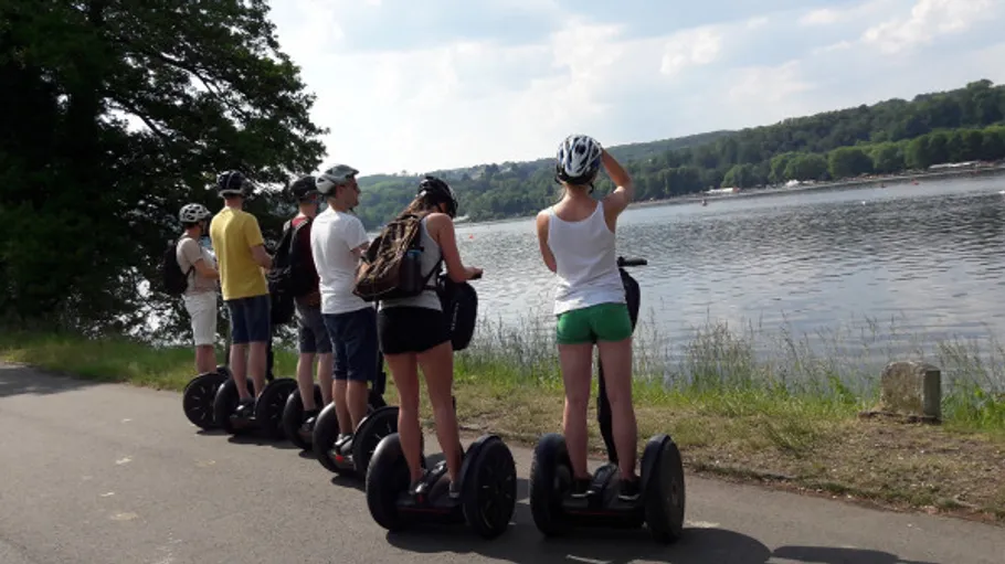 Group riding Segways near a lake.