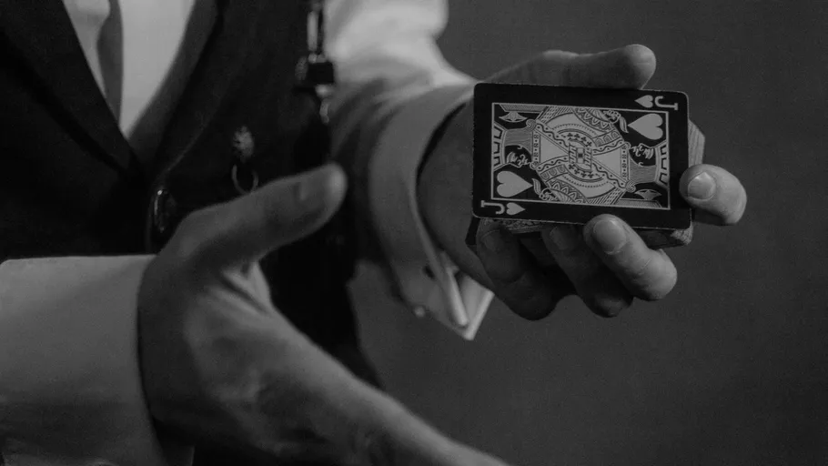 Magician showing a playing card, hand gesture.