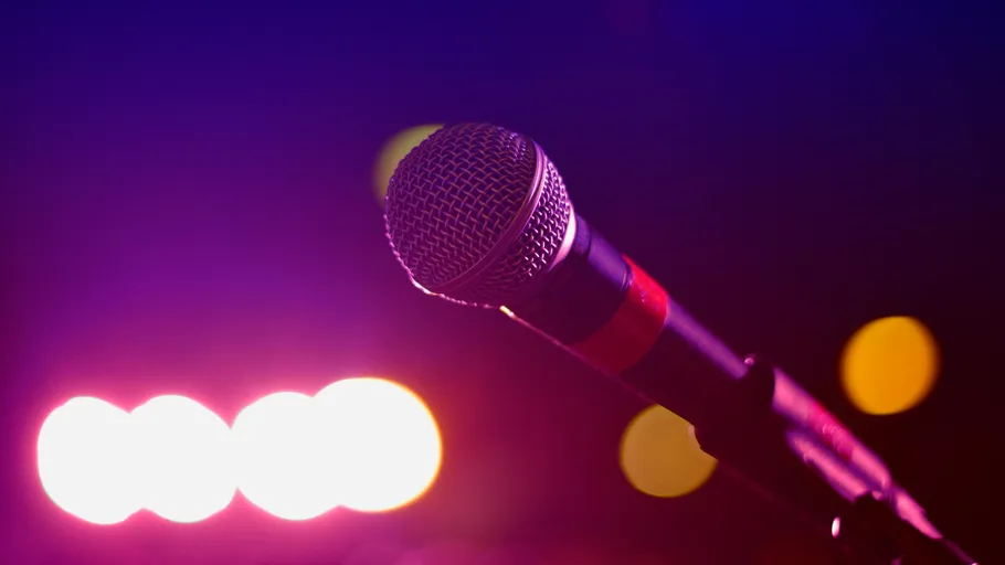 Microphone on stage with colorful lights.