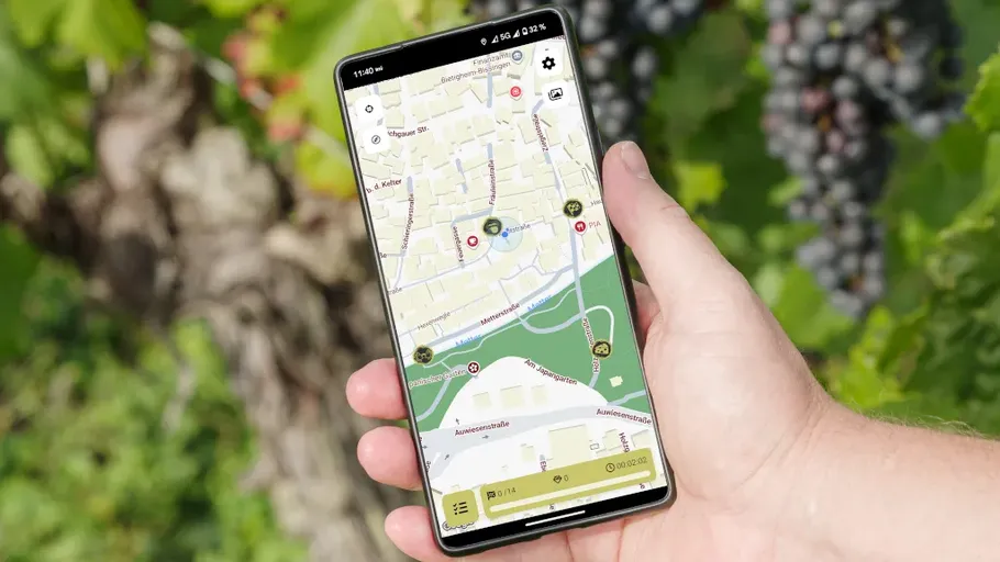 Hand holding smartphone displaying map app outdoors.