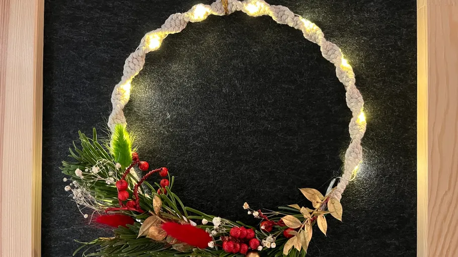 Decorative wreath with lights and greenery.