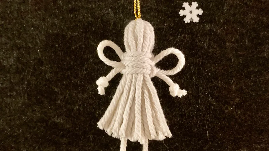 White yarn angel decoration with snowflake.