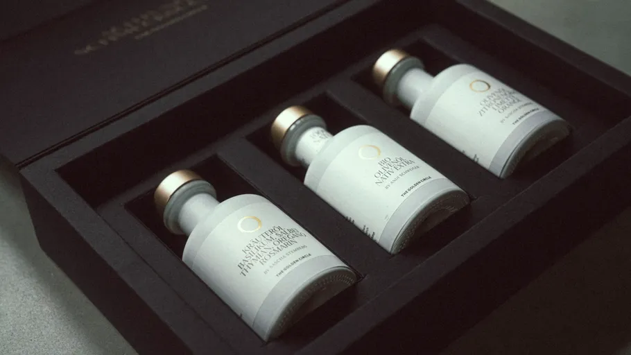 Three olive oil bottles in black box.