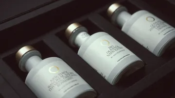 Three olive oil bottles in a black box.