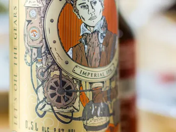Beer label with an artistic representation of a man and machines.
