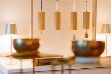 Wooden chimes hanging in a cozy room.