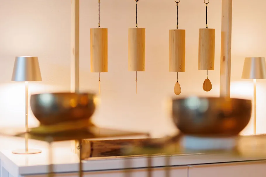 Wooden chimes hanging in a cozy room.