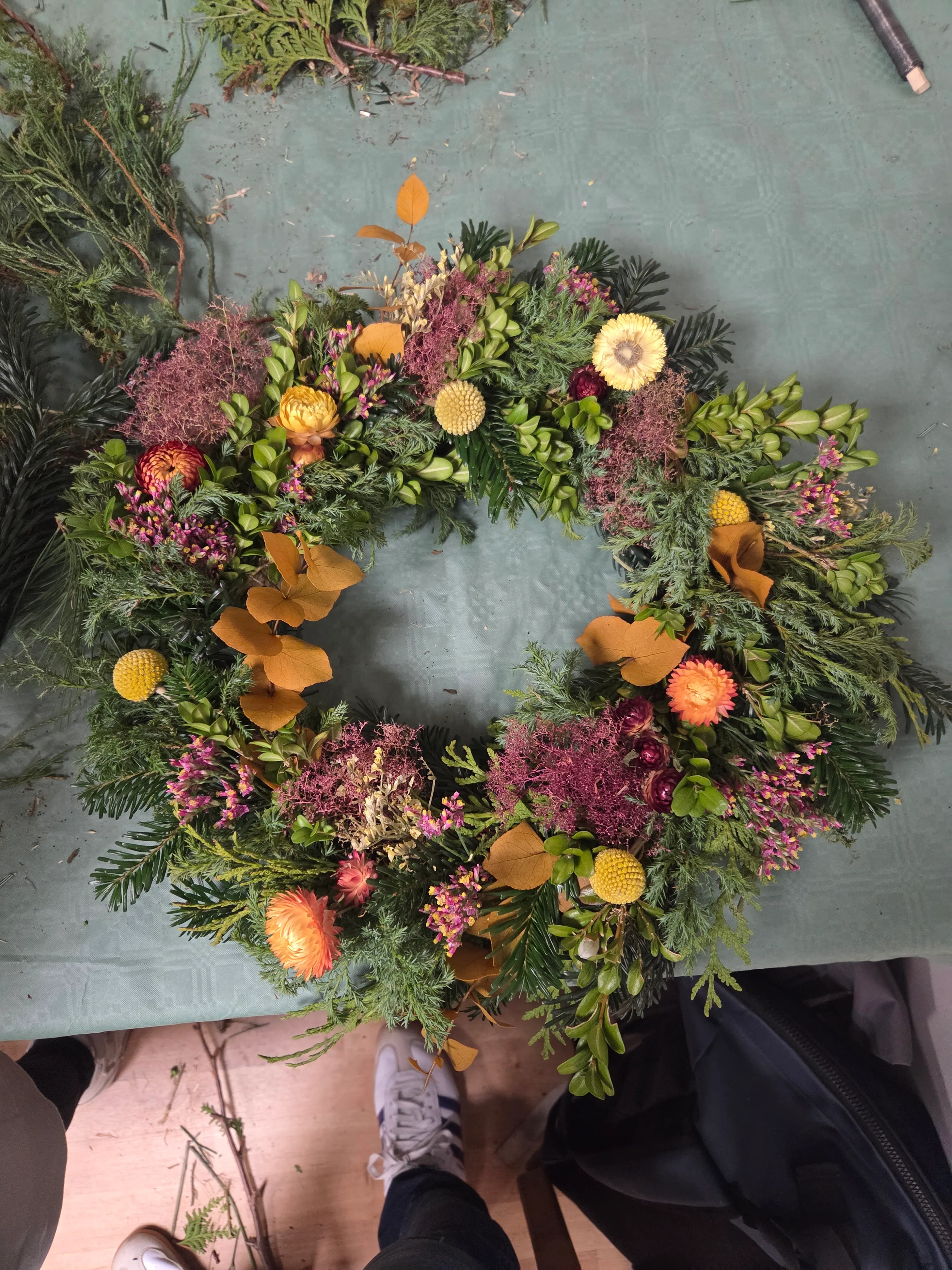 Decorative wreath on a green table.