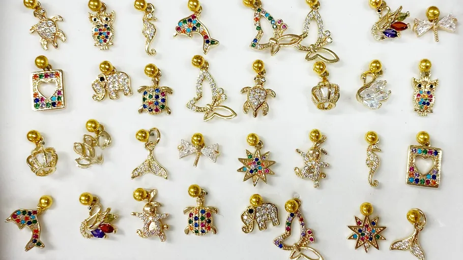 Colorful gold charms displayed on white background.