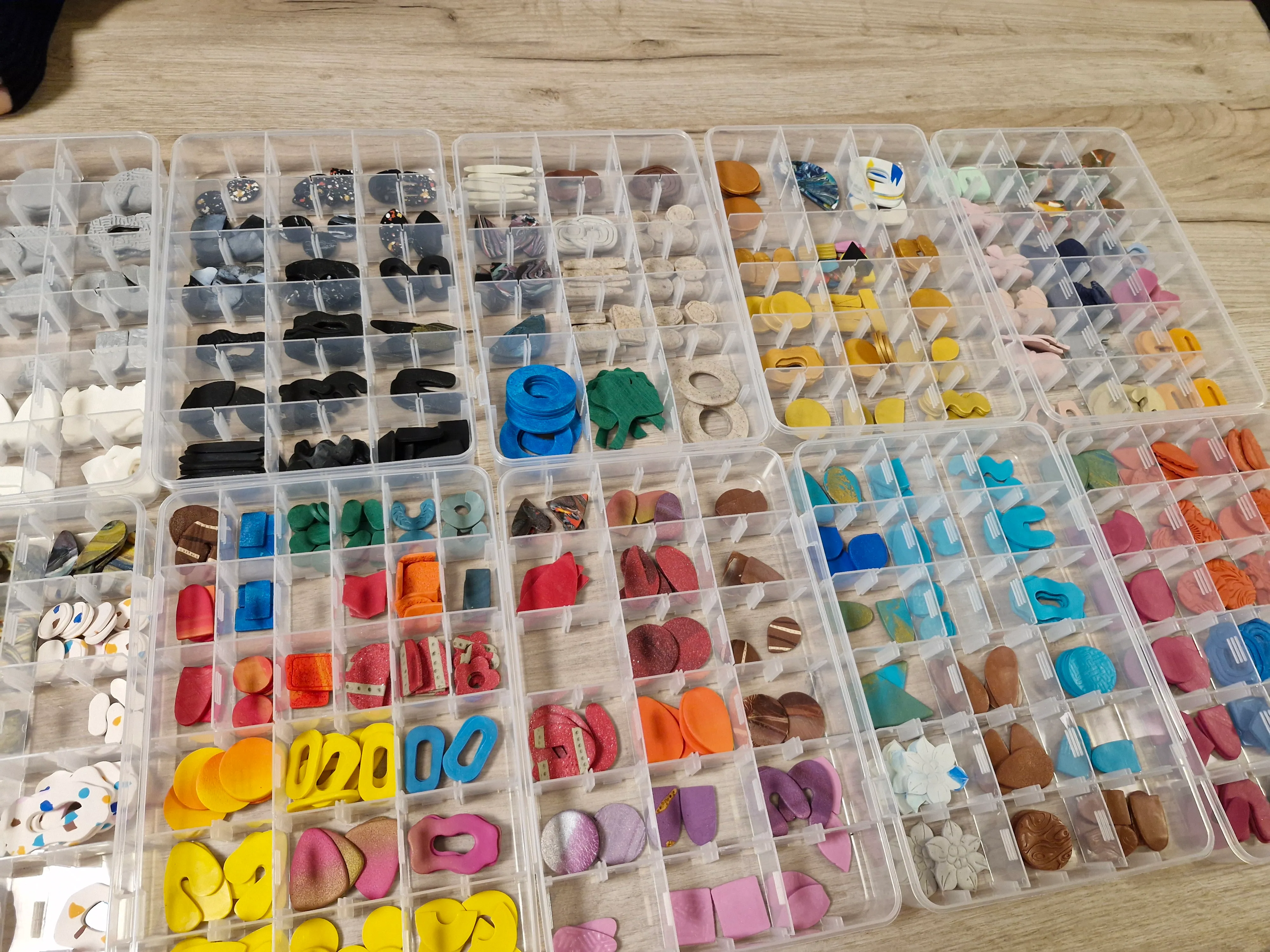 Assorted craft pieces organized in plastic containers.