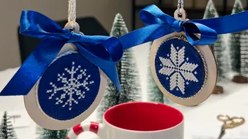 Snowflake ornaments with blue bows, festive setting.