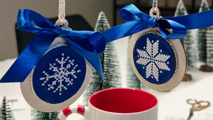 Snowflake ornaments with blue bows, festive setting.