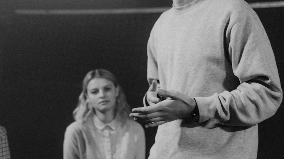 Person speaking, another listening attentively inside.