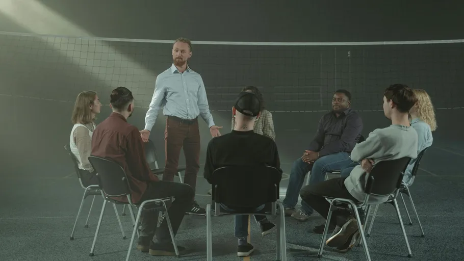 Group of people sitting in a circle, discussing.