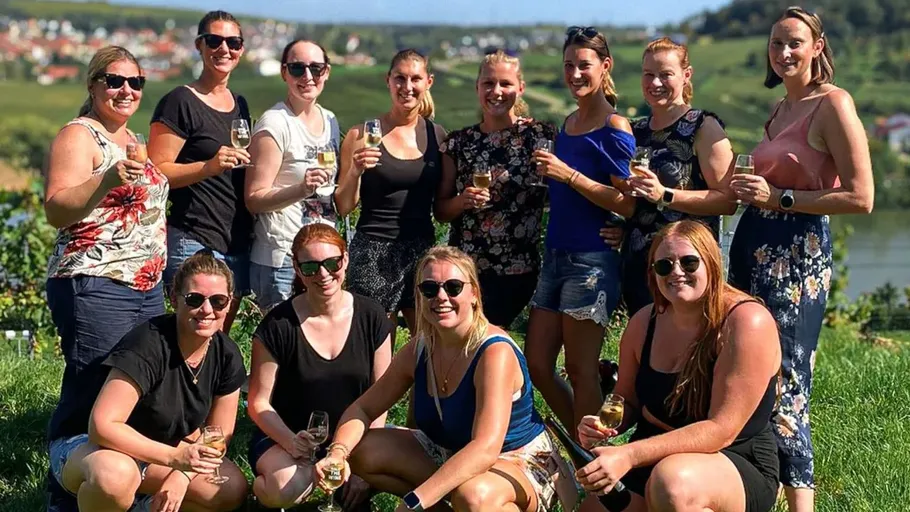 Group of women holding glasses outdoors.