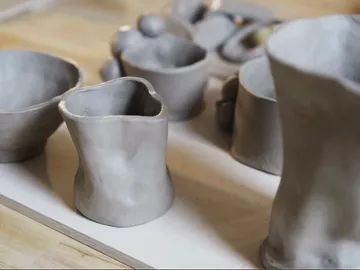 Grey clay pottery on a table.