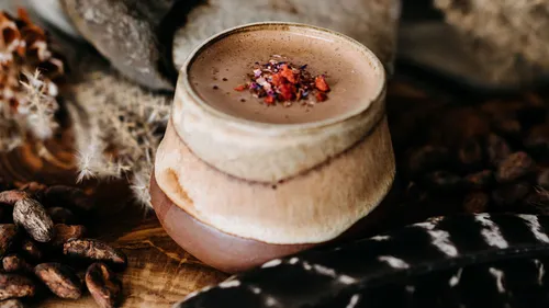 Ceramic cup with hot chocolate and spices.