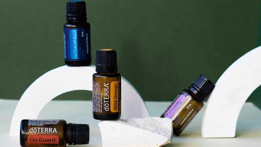 Essential oil bottles on abstract shapes.