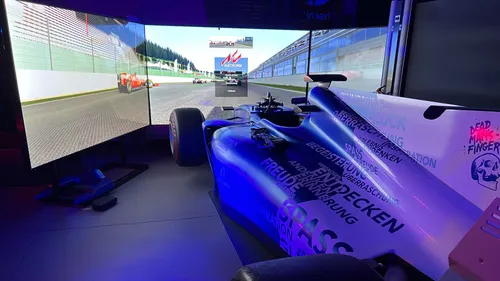 Race car simulator setup with screens.